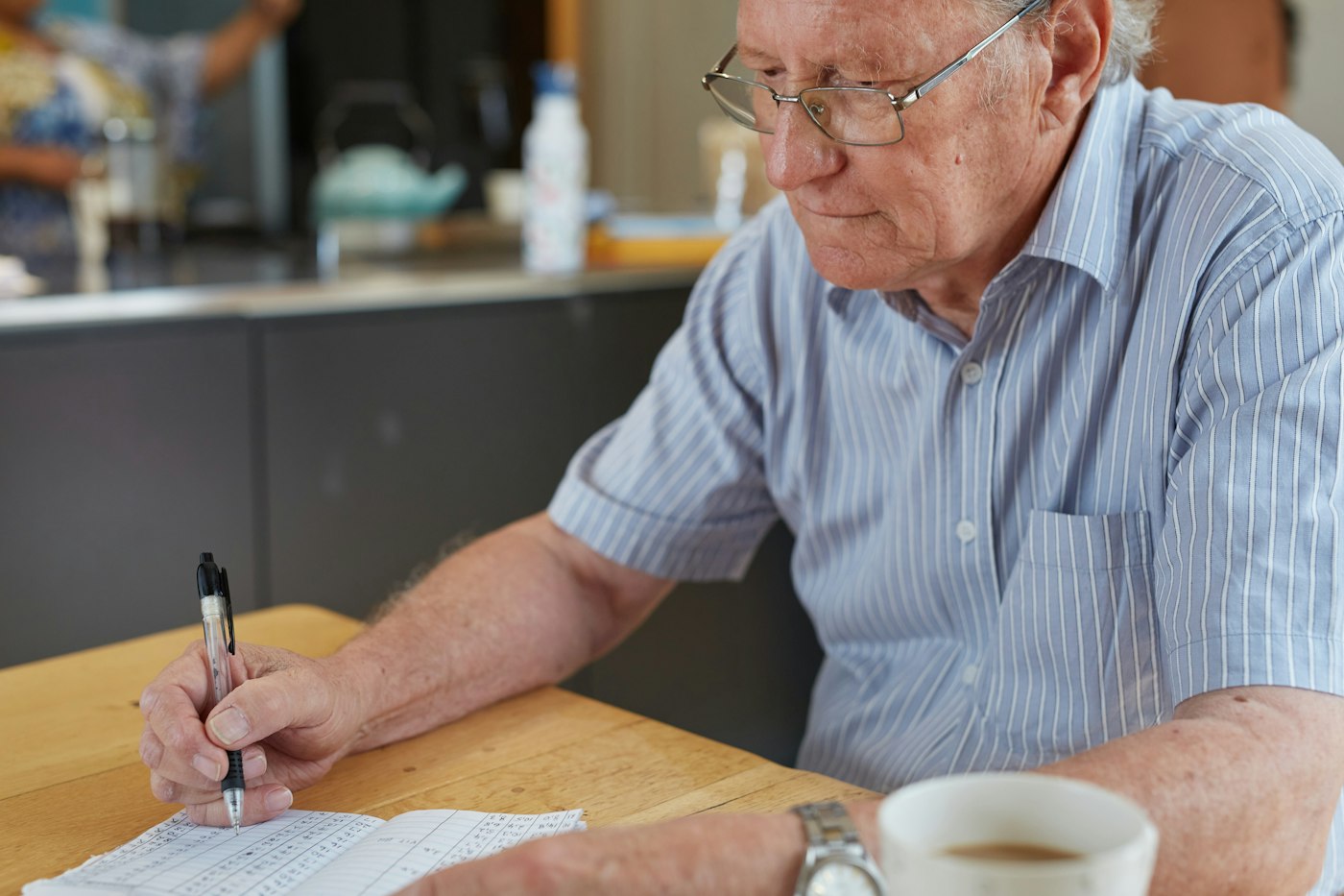 Older man going through paperwork at a table