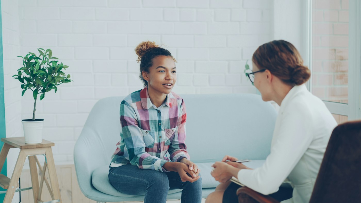 Counsellor talking with a client in a calm private practice room