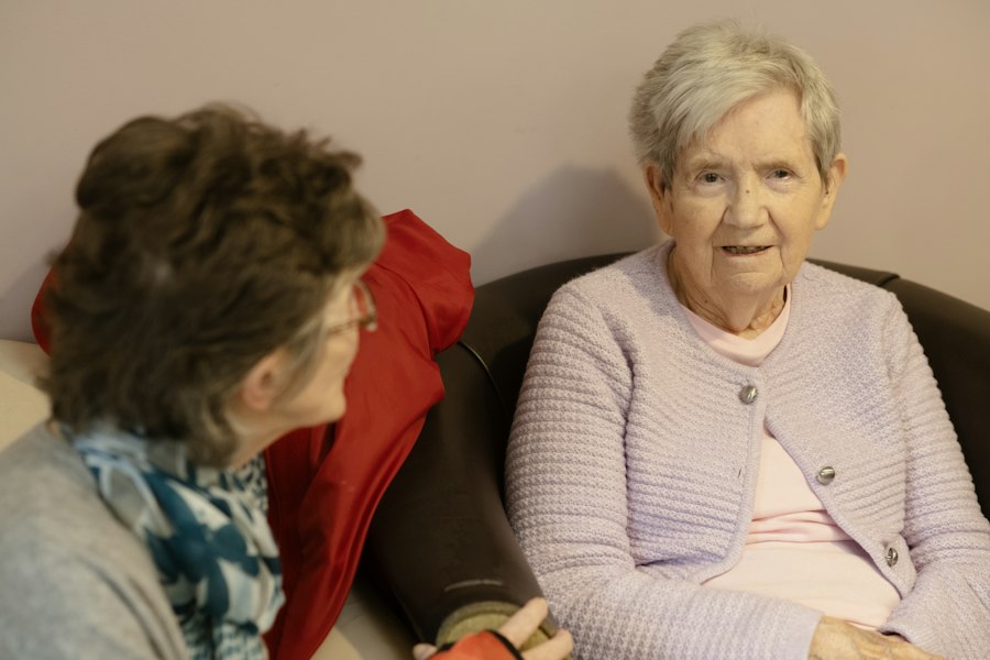 Home carer chatting with an older lady