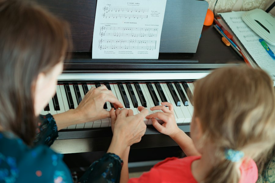 Music teacher at the piano with a young girl